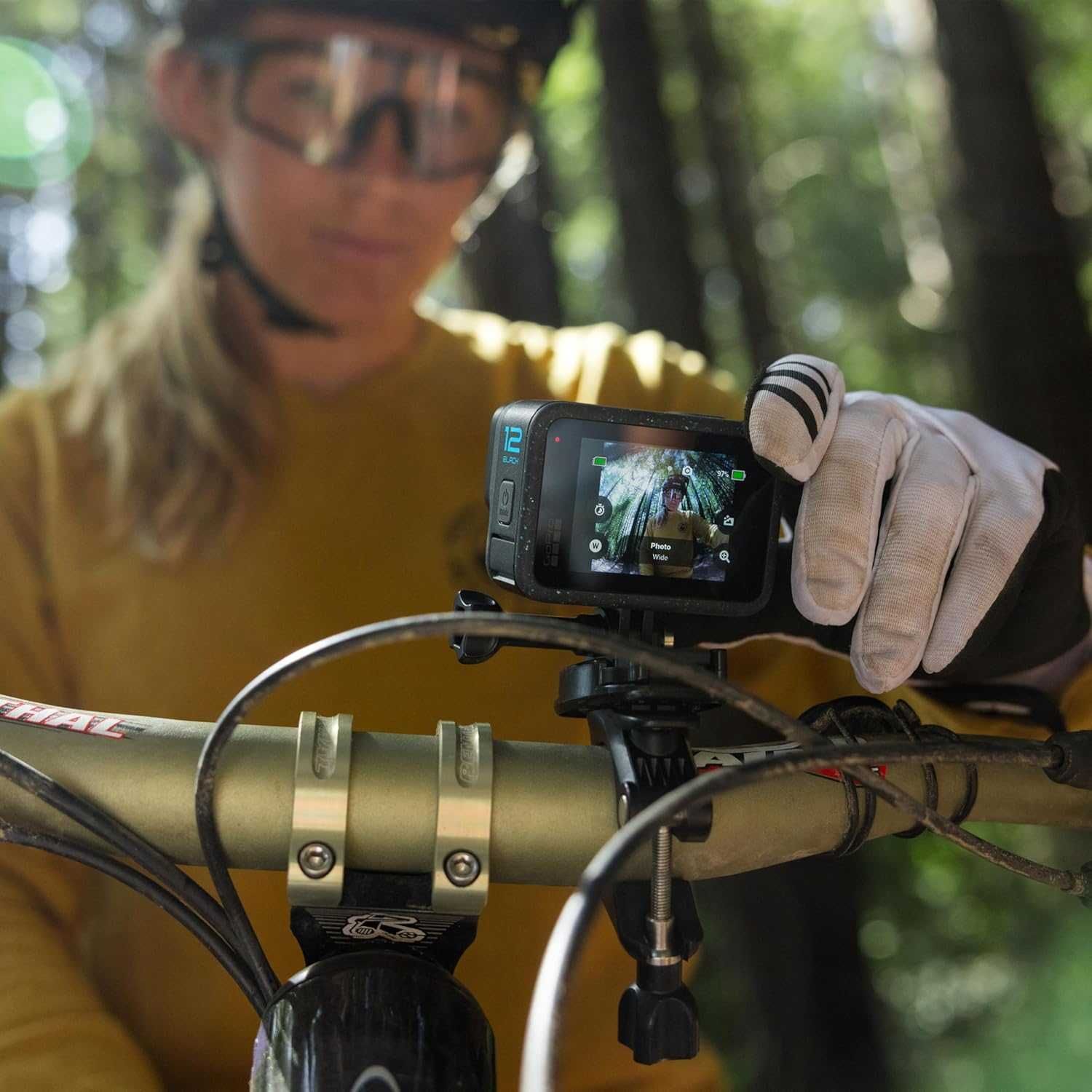 photo of a woman putting a GoPro Hero 12 camera on her handlebars.