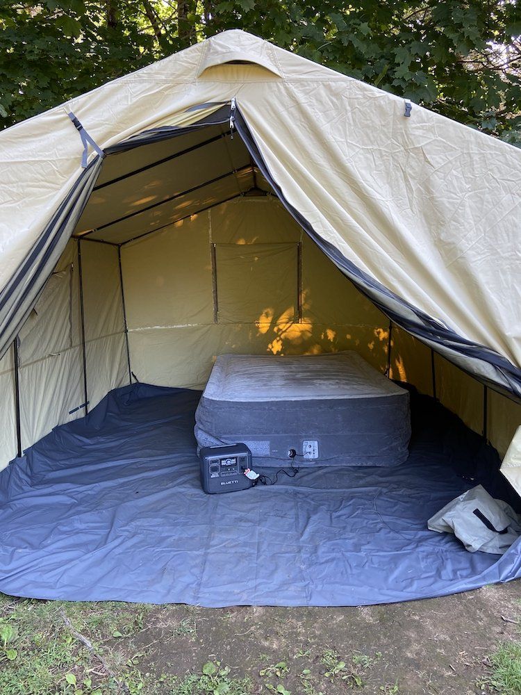 photo of Bluetti AC70 in a tent blowing up a inflatable mattress