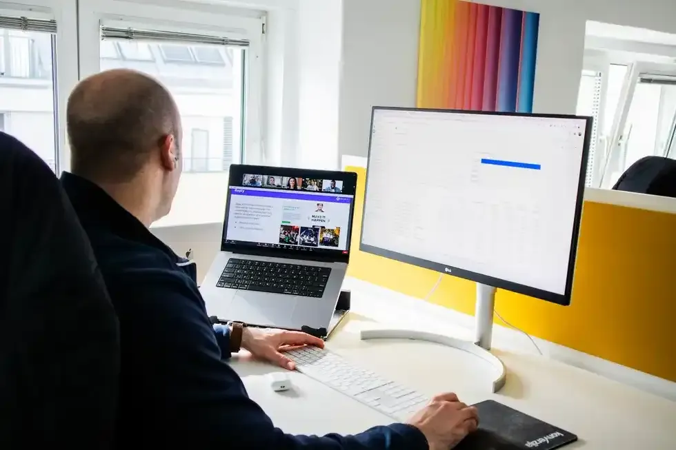 Man on a macbook in a. home offie