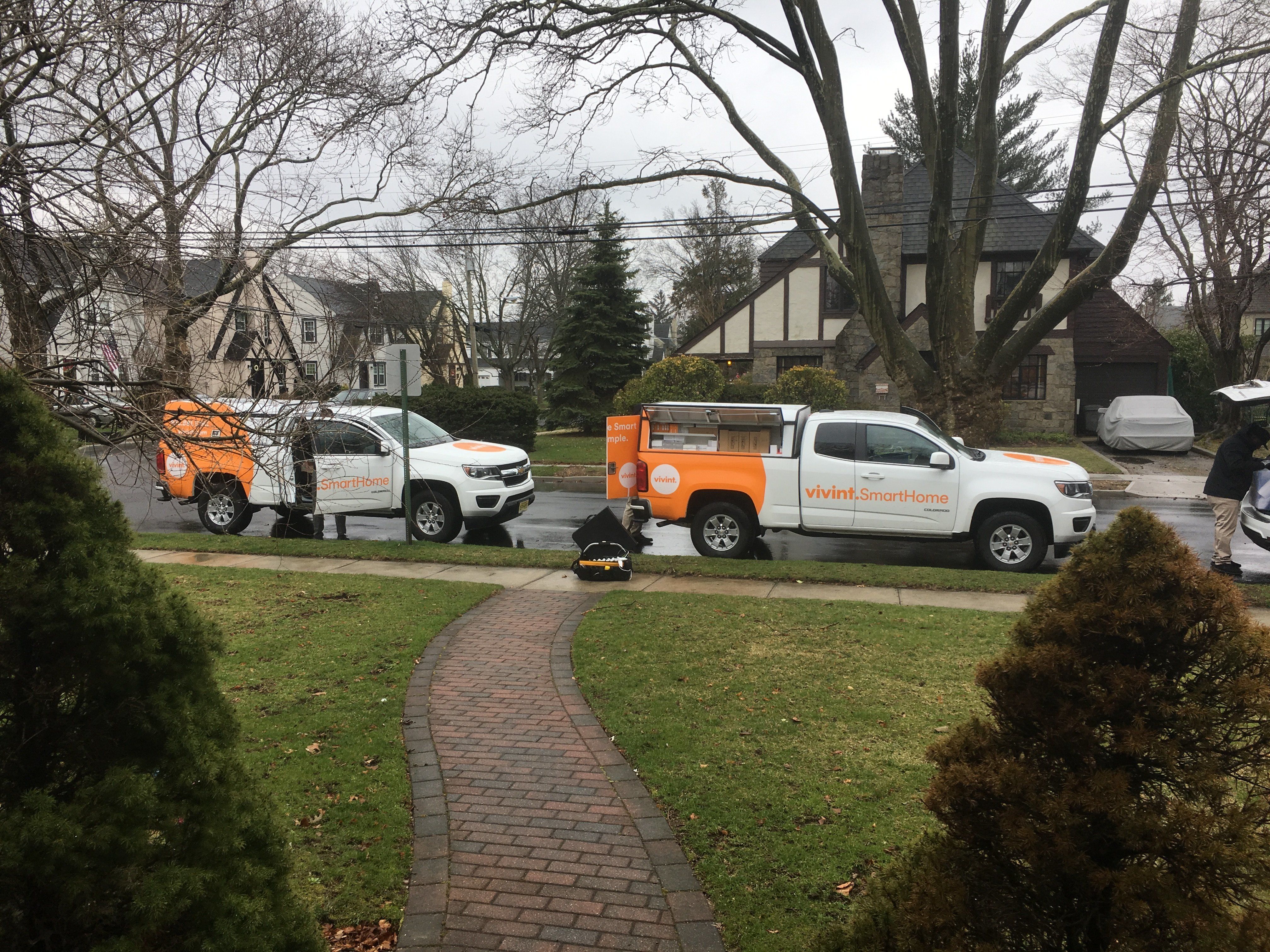 Vivint Smart Home installers trucks outside a house.