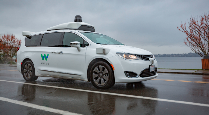 Photo of Waymo driverless car on wet road