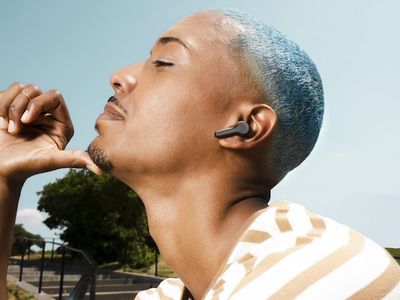 a photo of a man wearing Echo Buds (2023 release) outside.