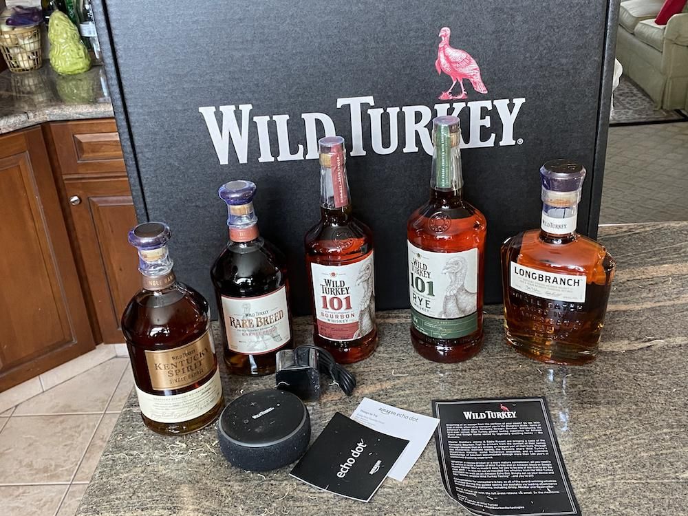 Wild Turkey bottles on a counter with Amazon Echo Dot and instructions