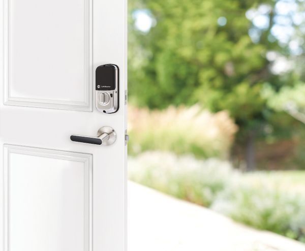 A smart lock from Yale and LiftMaster on a door that opens outside