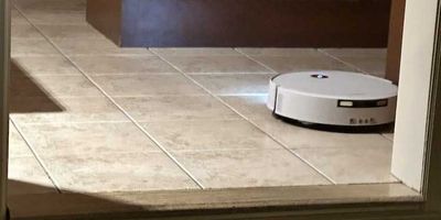 photo of Yeedi M16 Infinity vacuuming the floor with lights on