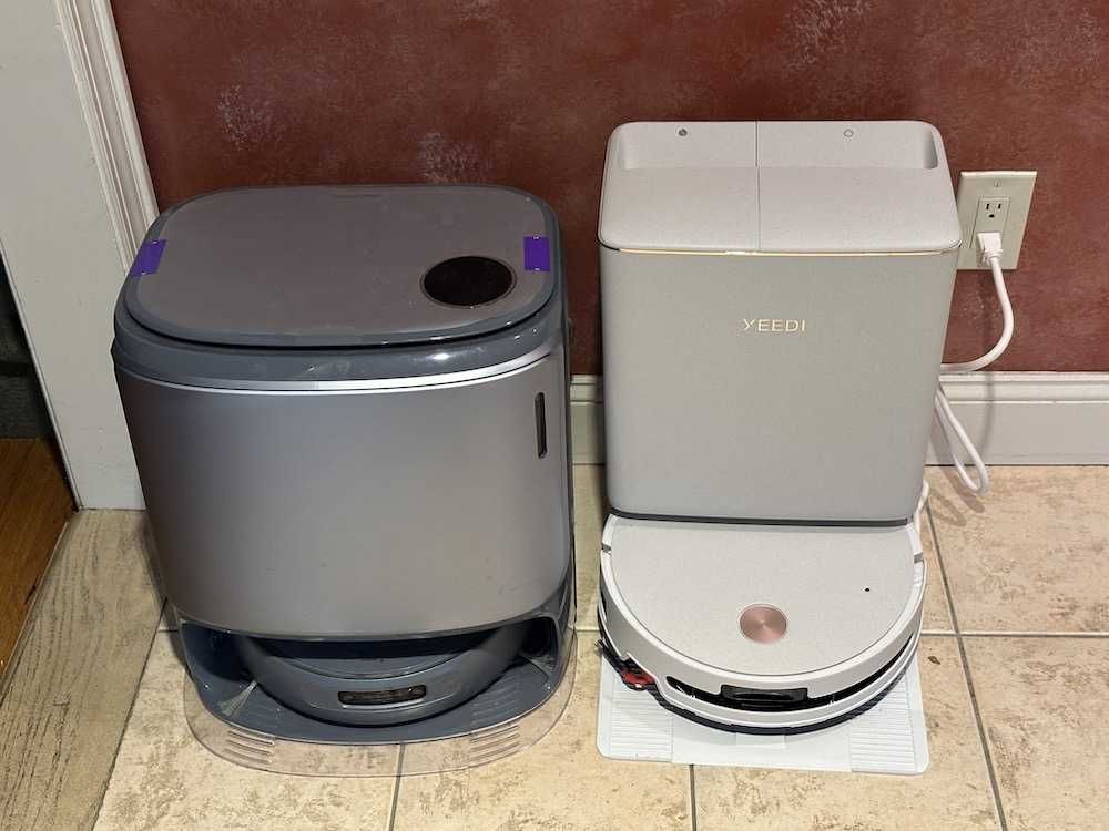 a photo of Yeedi M16 Infinity and Narwal Freo with their emptying stations.