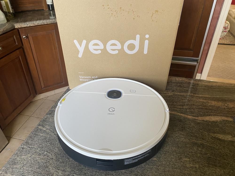 photo of yeedi vac robot vacuum and mop on a countertop unboxed.