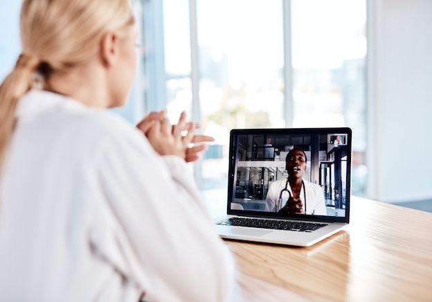 A patient talking to a doctor on a computer