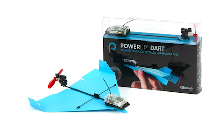 A PowerUp Dart in blue next to the packaging on a white table