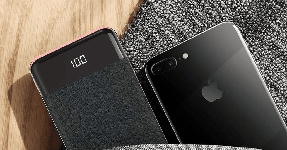 Lifestyle image of a power bank by Cornmi next to an iPhone