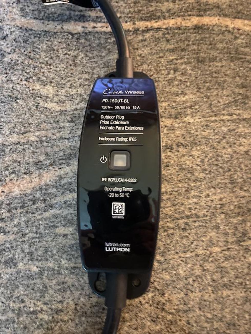 Lutron Outdoor Smart Plug on a counter showing off it's sleek and durable design.