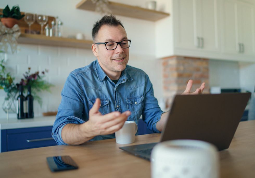 Man having a video call with a laptop at home