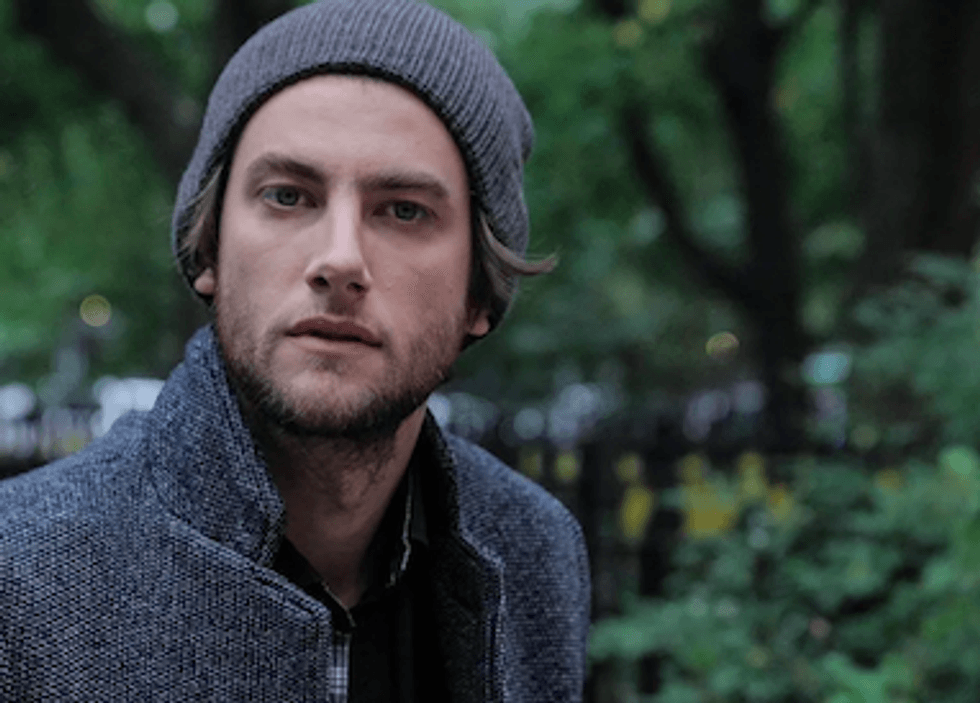 Man wearing the 1 Voice Beanie in dark gray