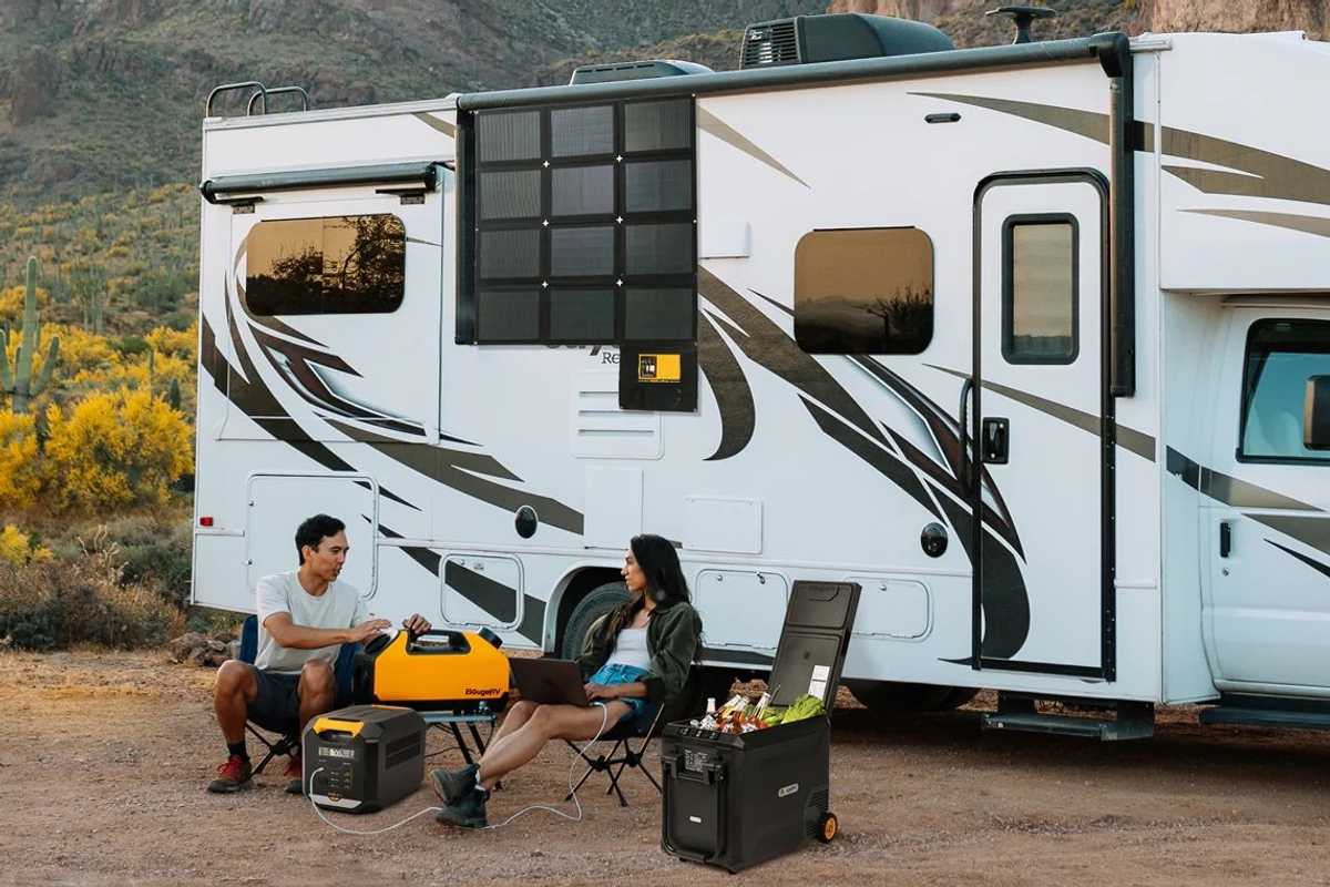 People sitting outside with their RV using BougeRV devices at a camp site.