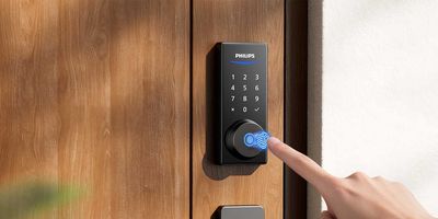 photo of Philips 4000 Series smart lock on a door being unlock by a finger.