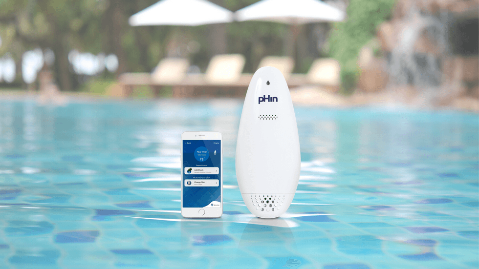 pHin Smart Water Monitor and smartphone with app in pool