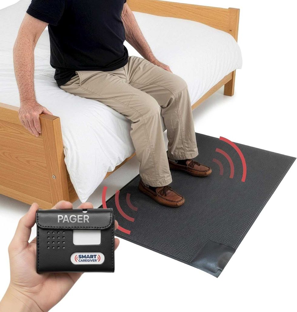photo of a elderly male sittiing on the side of a bed with feet on a smart bed mat.
