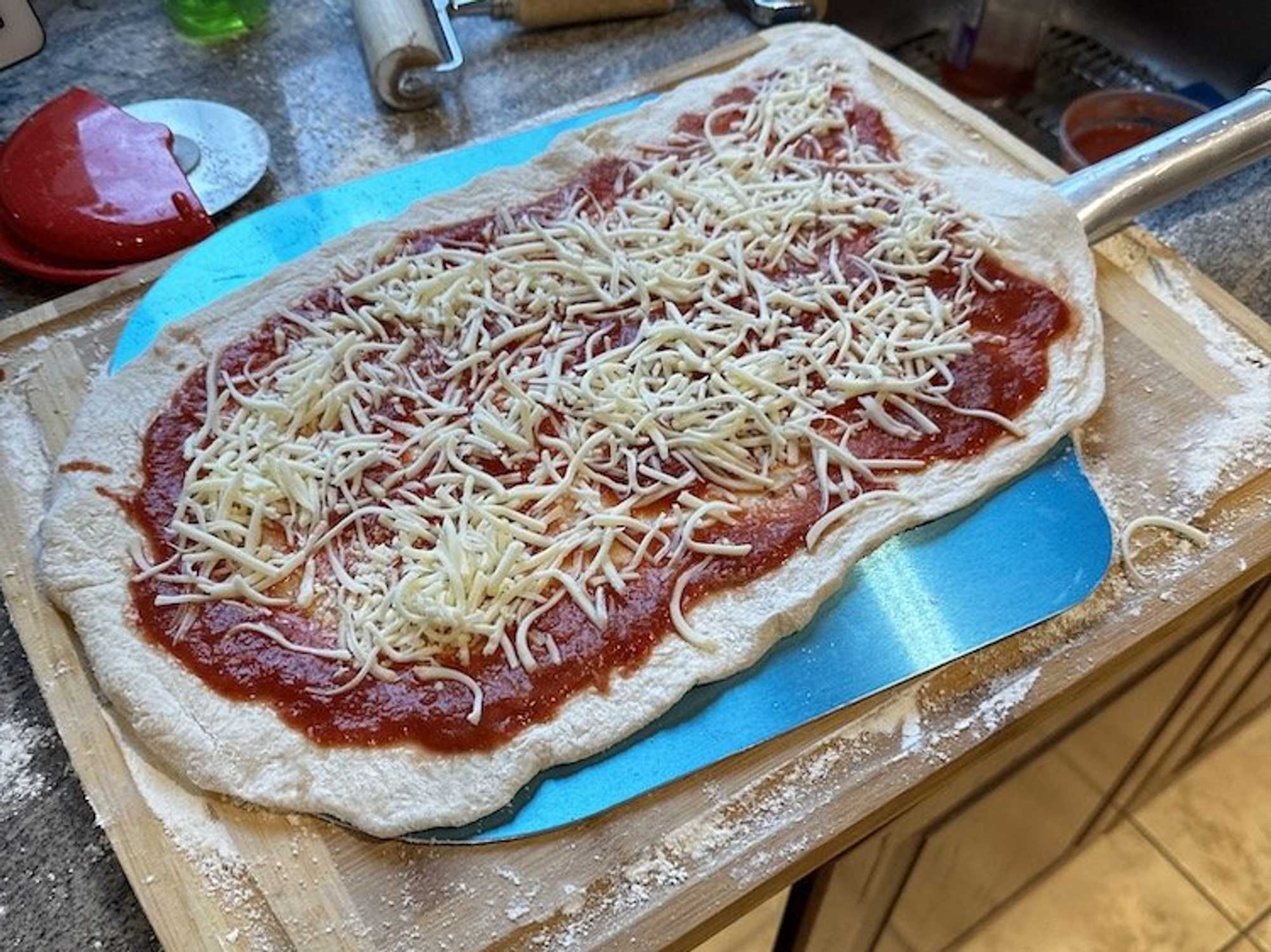photo of a homemade pizza on a pizza peel