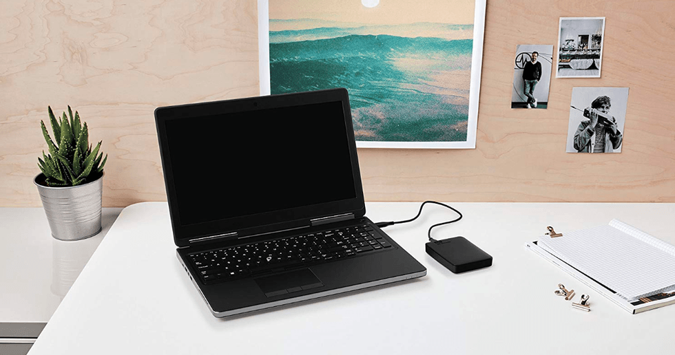 Photo of a laptop and local backup drive