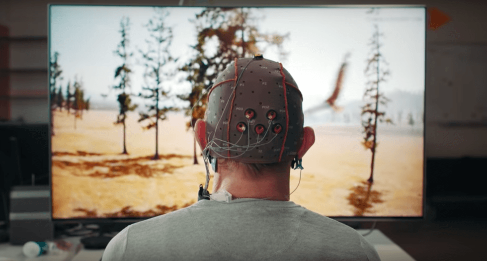 photo of a man wearing a headet to control his tv