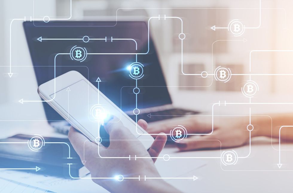 photo of a smartphone and computer with bitcoin