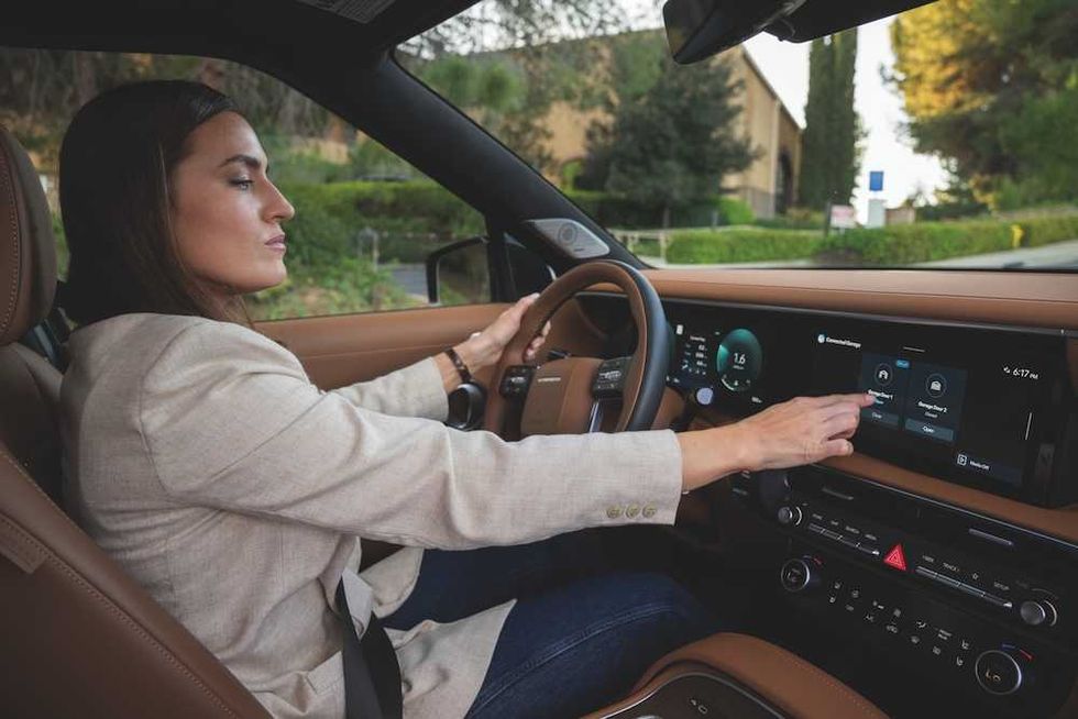 photo of a woman driving in a Hyundai activating Hyundai myQ Connected Garage on her dashboard