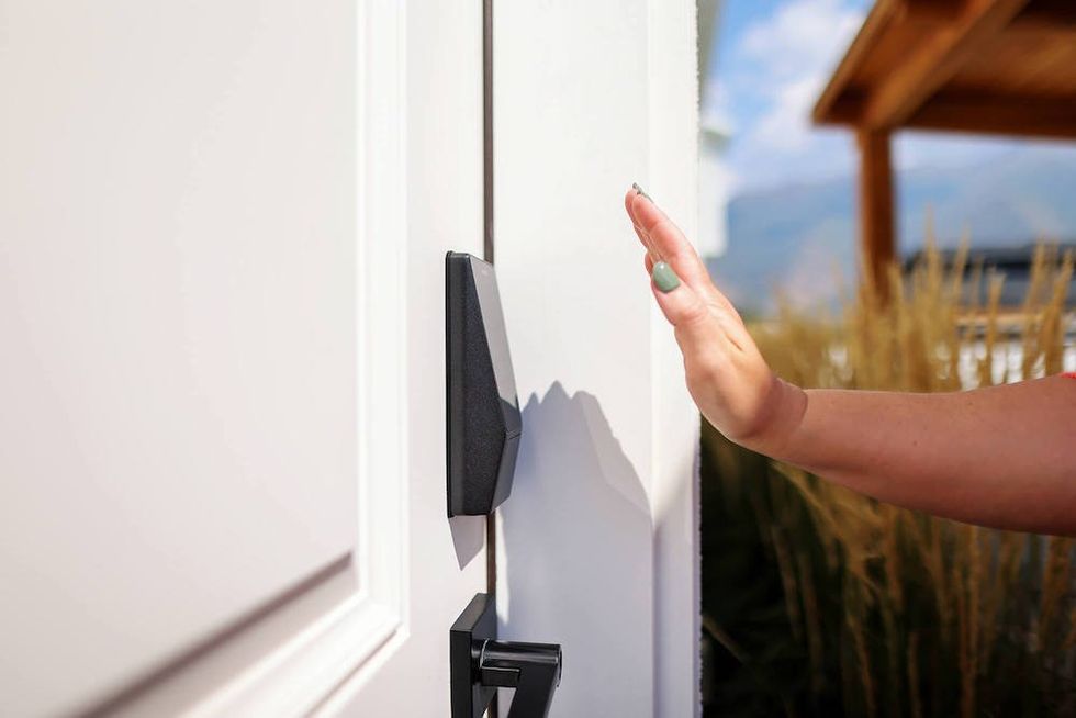 photo of a woman's hand over Wyze Palm Lock
