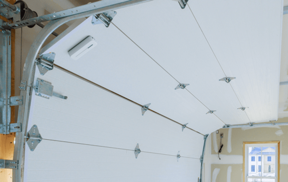 photo of Abode Garage Tilt Sensor on a garage door