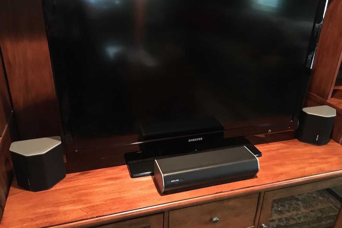 Photo of Enclave CineHome II Wireless Home Theatre System infront of a smart tv.