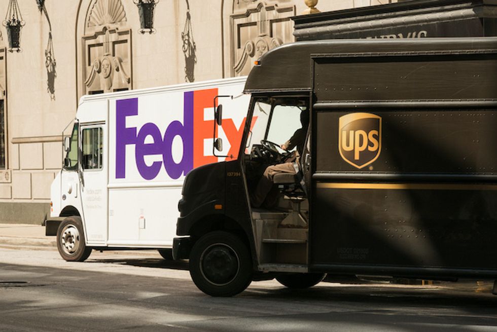 photo of fedex and UPS trucks on the street