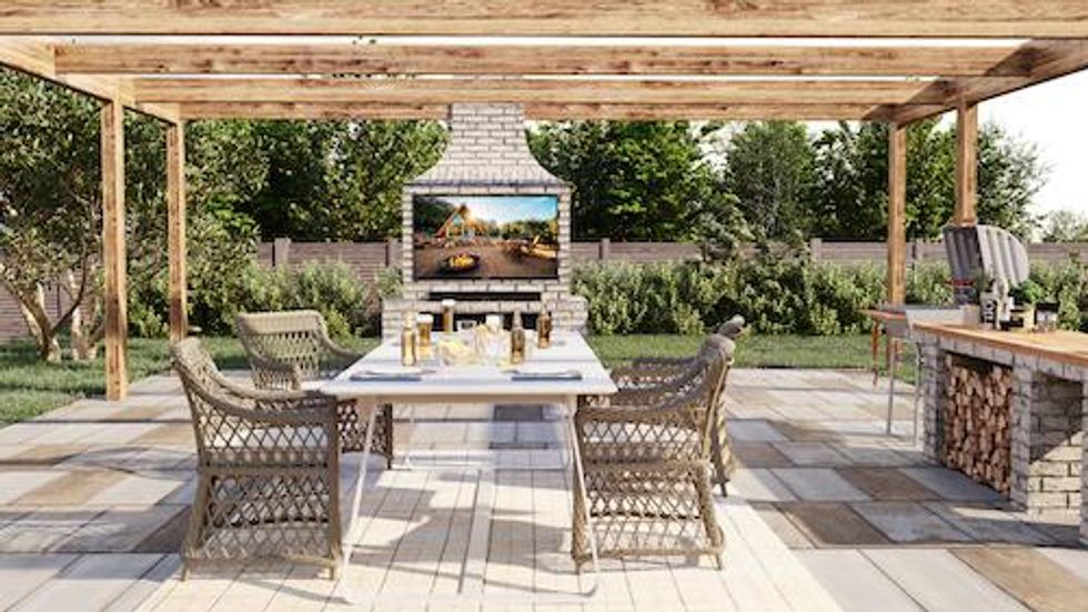 Photo of Furrion Aurora Smart Outdoor TV outside in a backyard in full sunlight