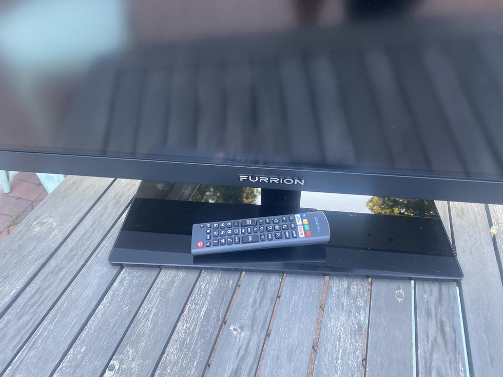 photo of Furrion TV with remote control