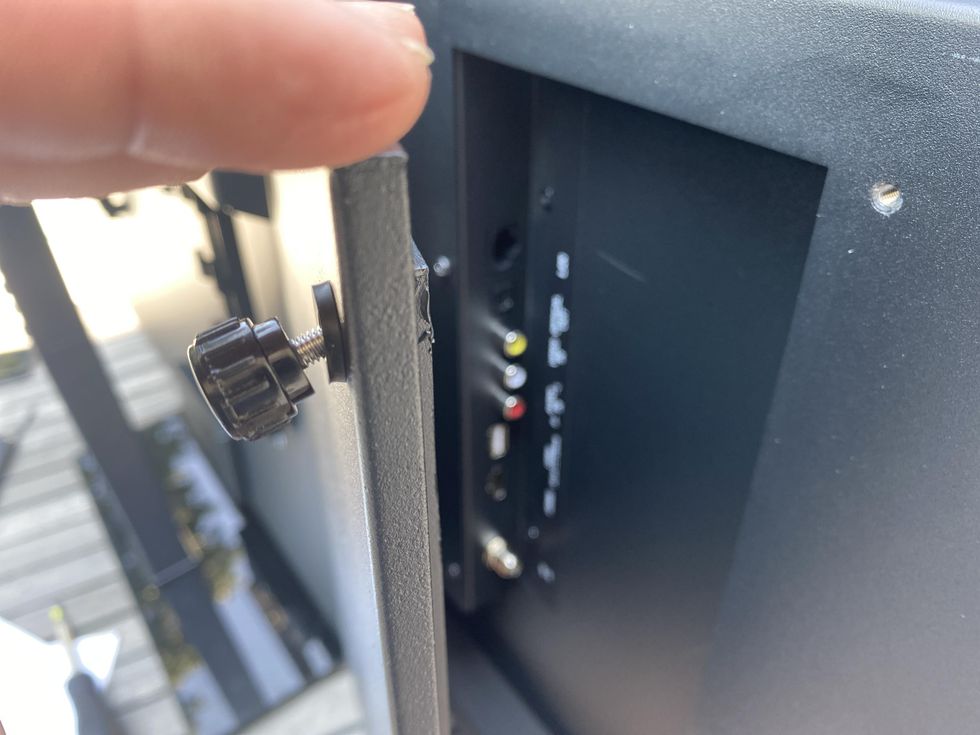 Photo of inputs are in casing behind the TV and protected from the elements