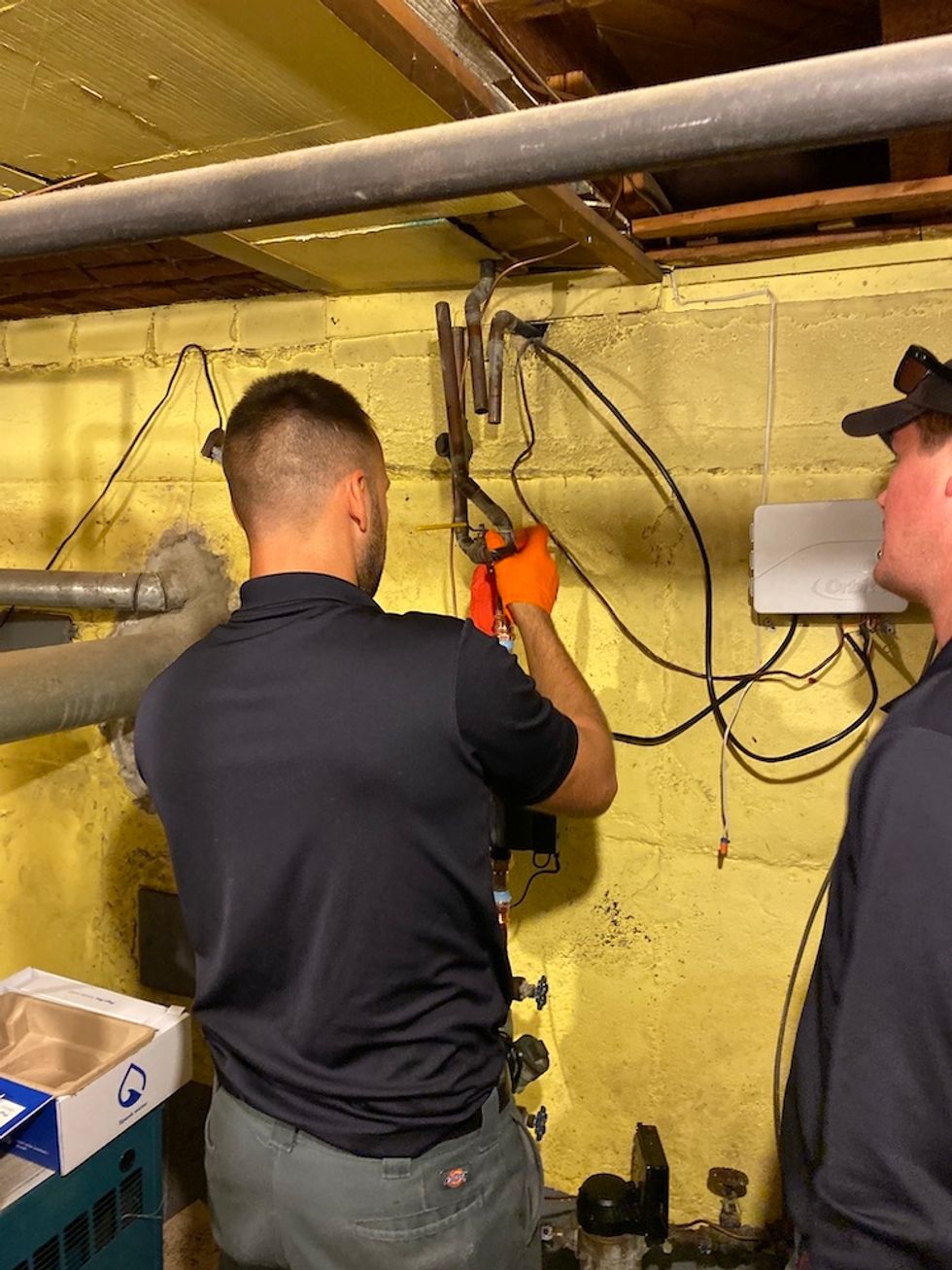 Photo of licensed plumber installing Phyn plus