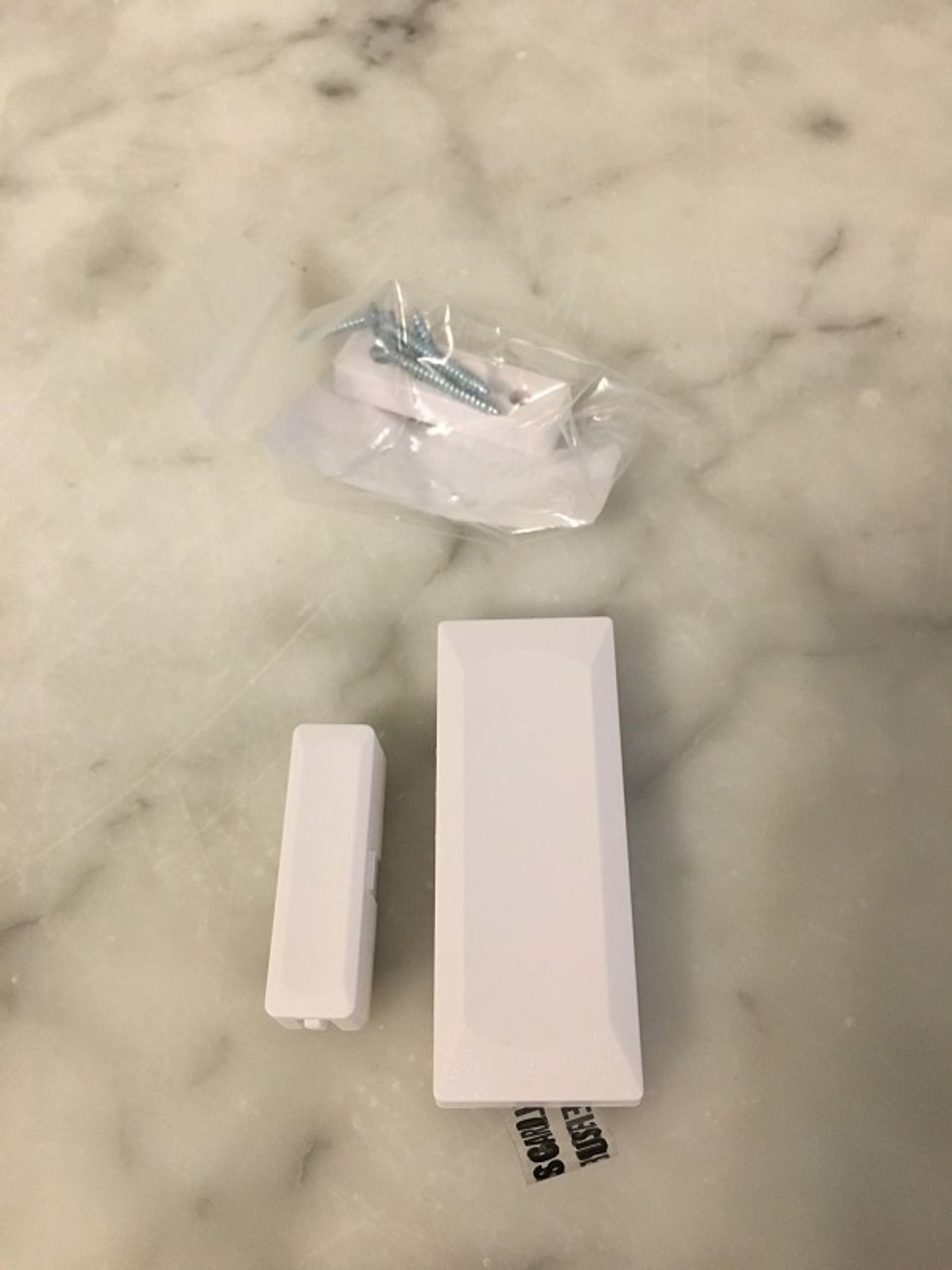 Photo of Lifeshield window sensors on a counter.