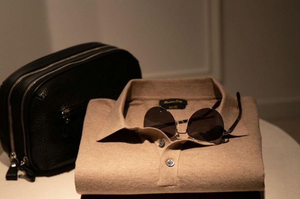 photo of men's shirt, sunglasses and overnight bag.
