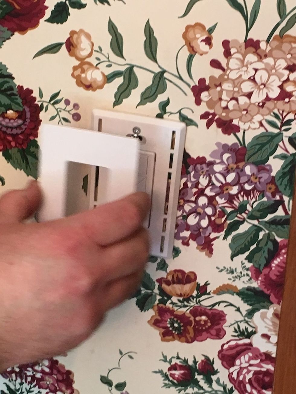 Photo of placing cover plate on a Lutron Caseta Switch
