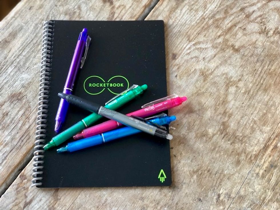 Photo of Rocketbook's Everlast with a microfiber cloth and five different colored FriXion gel ink pens