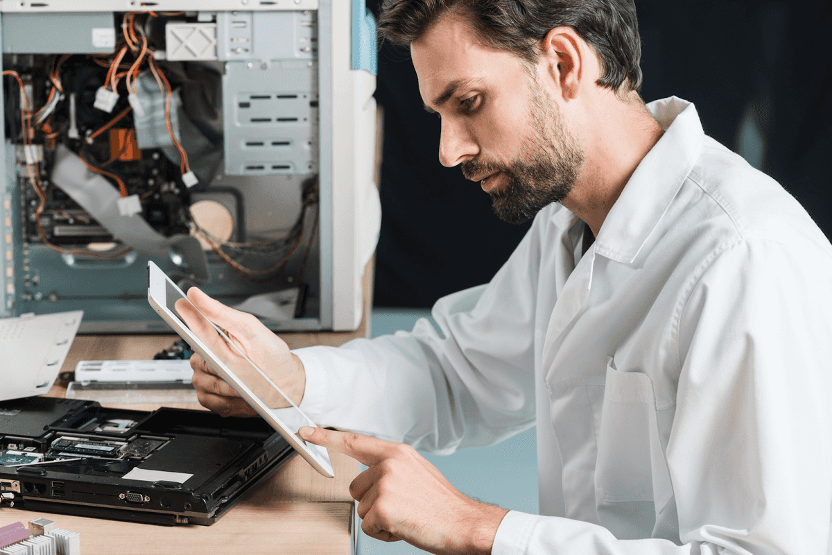photo of side-view-male-technician-using-digital-tablet
