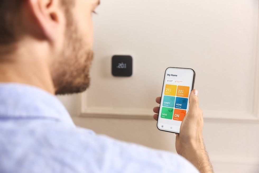 photo of smartphone showing tado app controlling tado smart thermostat