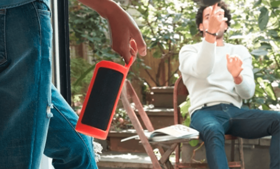 Photo of two men outside playing music on Amazon Echo Tap portable speaker