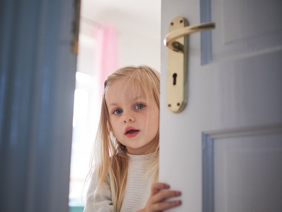 Picture of little girl opening a door with smartlock.
