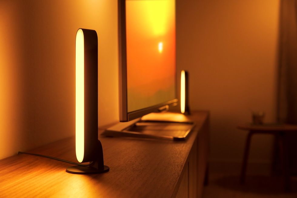 Picture of Philips Hue Play lights on a shelf next to a smart tv.