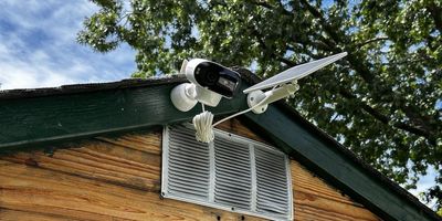 a photo of Reolink Argus 4 Pro and solar panel installed on a shed