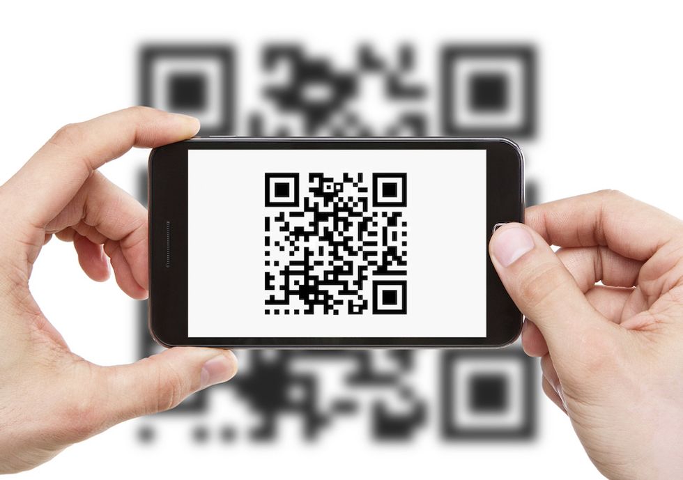 Scanning QR code with smart phone, which viewers will be able to do while watching TV to buy items on some NBC Universal channels