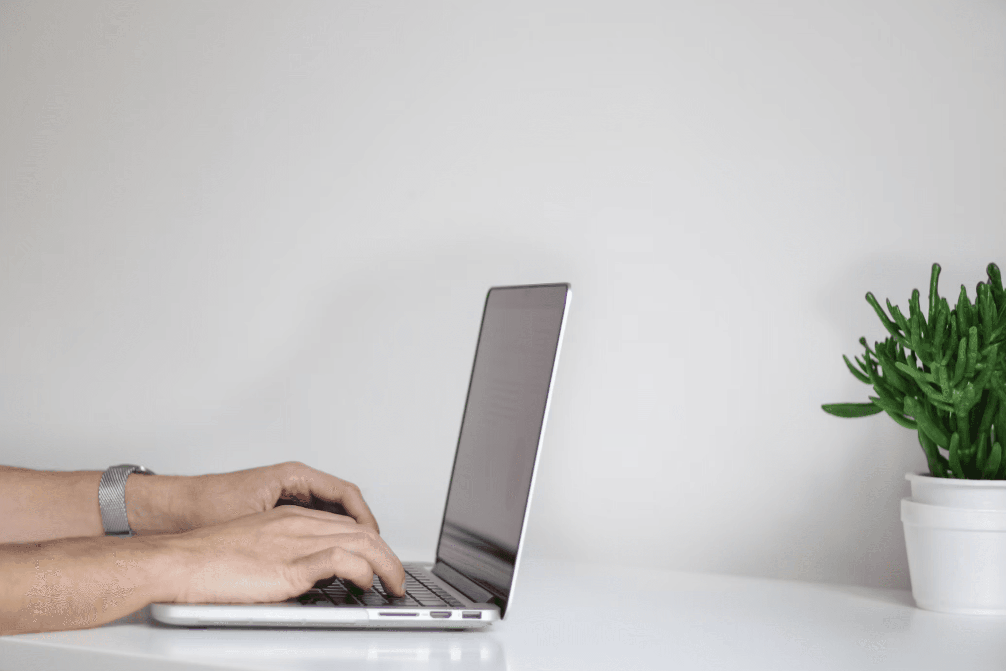 photo of hands on a laptop typing