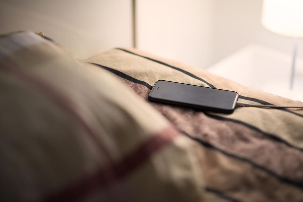 Smartphone charging on a bed