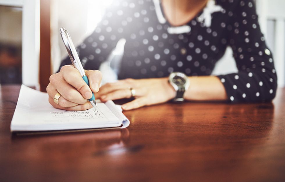 Someone making a list with pen and paper