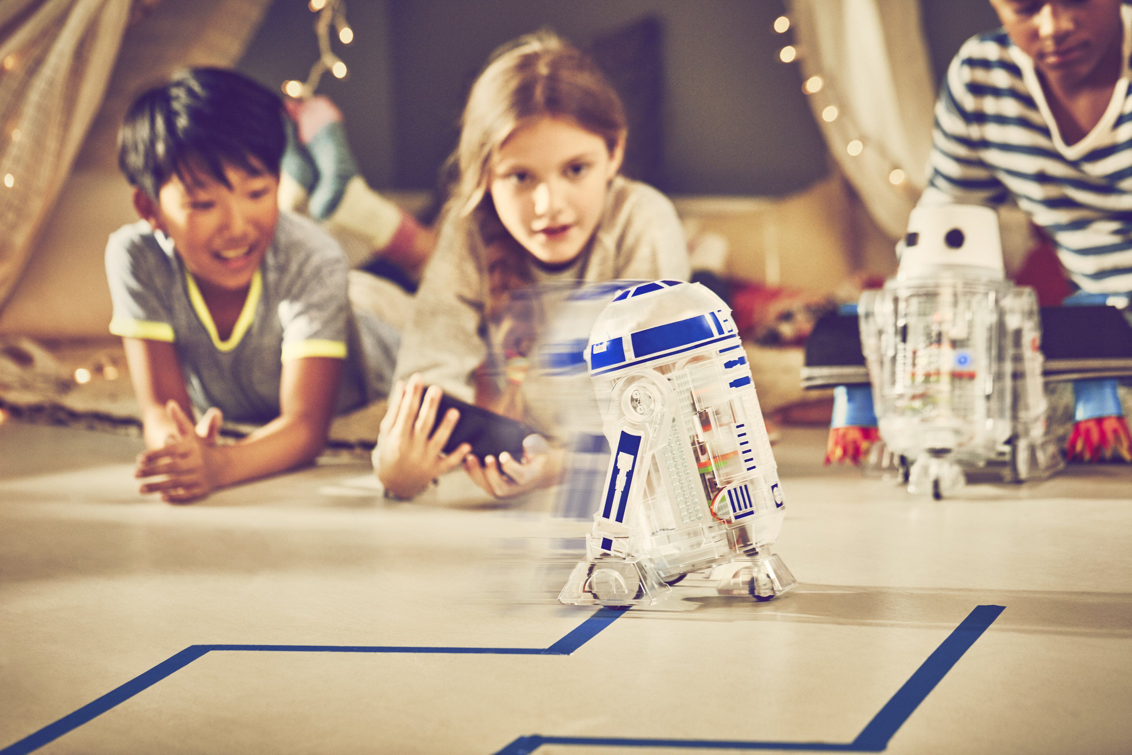 kids olaying with a toy robot