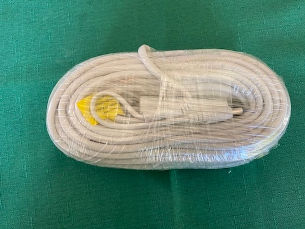 Swann Spotlight Cam power cord on a table.